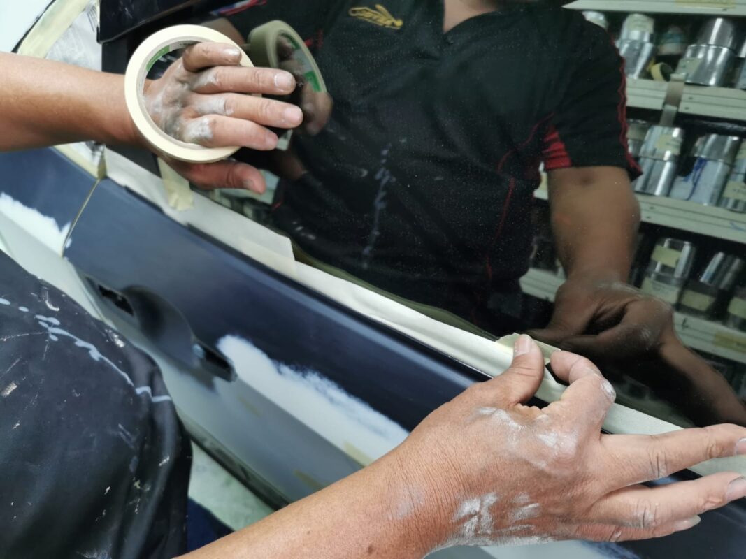 Further masking on the Honda Civic, protecting trim and glass.