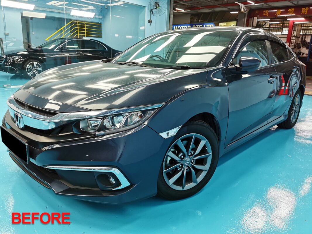 The Honda Civic in the spray booth receiving the new coat.