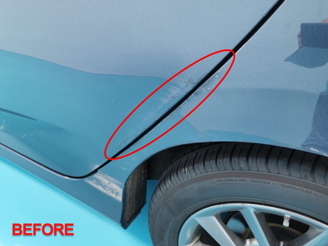 Machine-polishing the Honda Civic after painting to bring up the gloss.