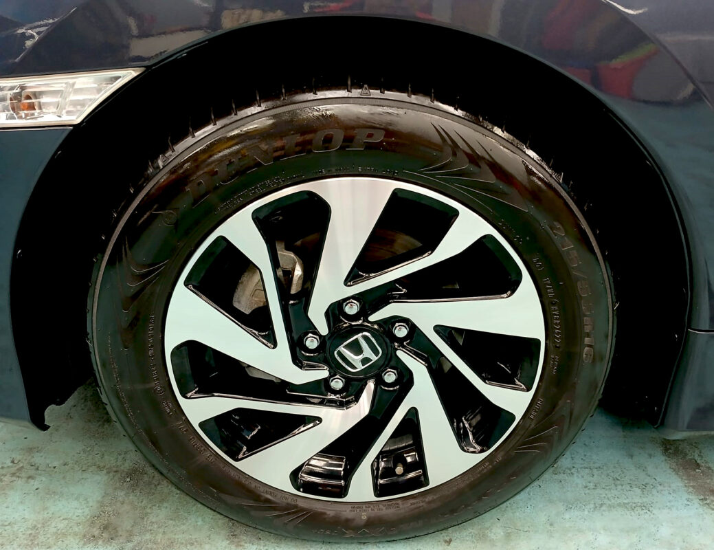 The coated bodywork of the Honda Civic under workshop lighting.
