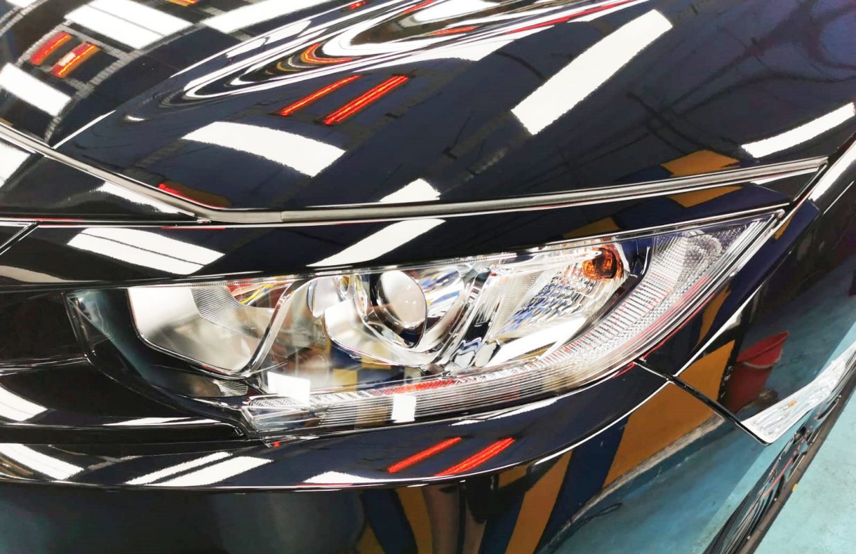 The Civic's coated paintwork holding clean reflections.