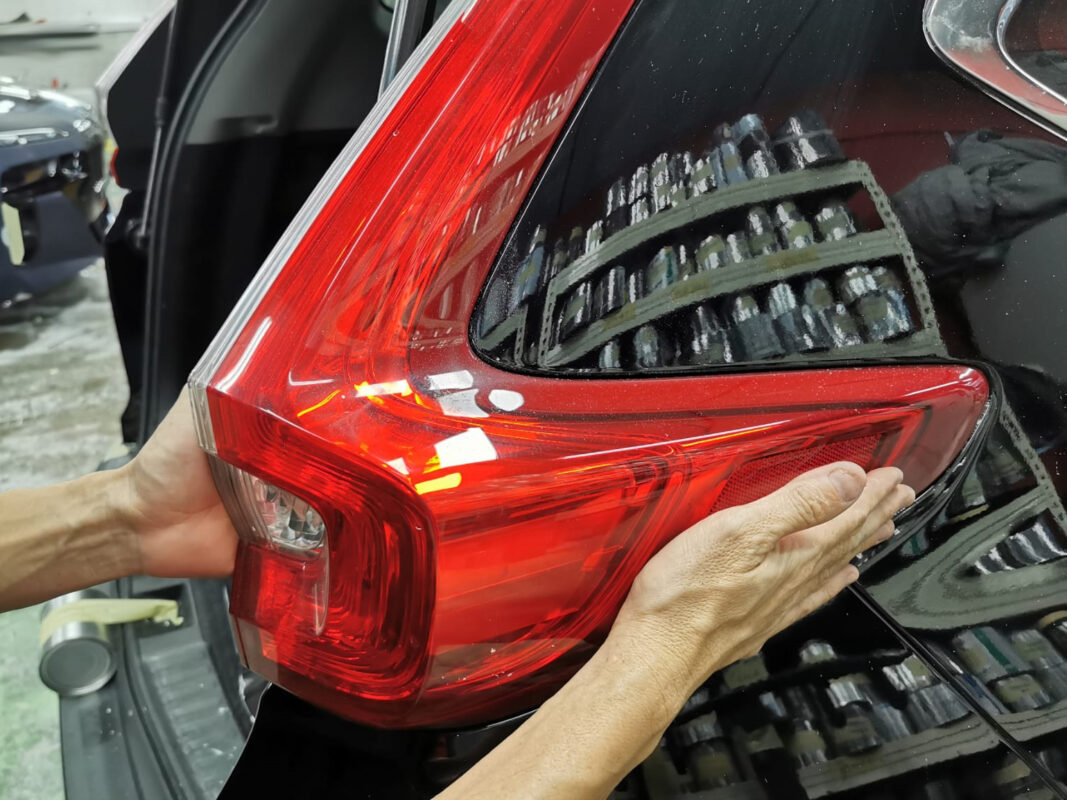 Newly painted surface of the Honda CR-V being inspected after spraying.