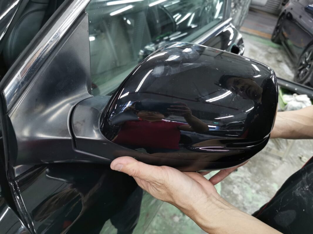 Technician polishing the Honda CR-V paintwork to bring up the gloss.