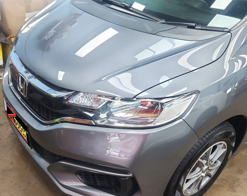 The Honda Fit from a side angle after the ceramic coating.
