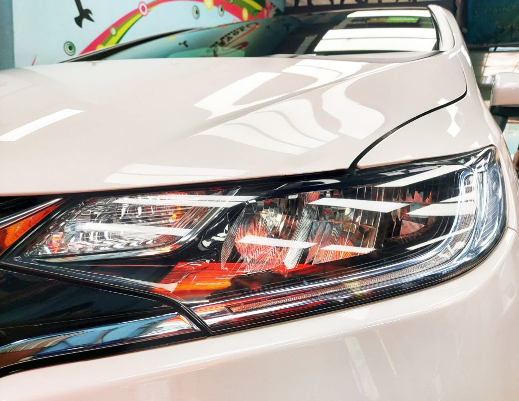 The Fit Hybrid's coated paintwork holding clean reflections.