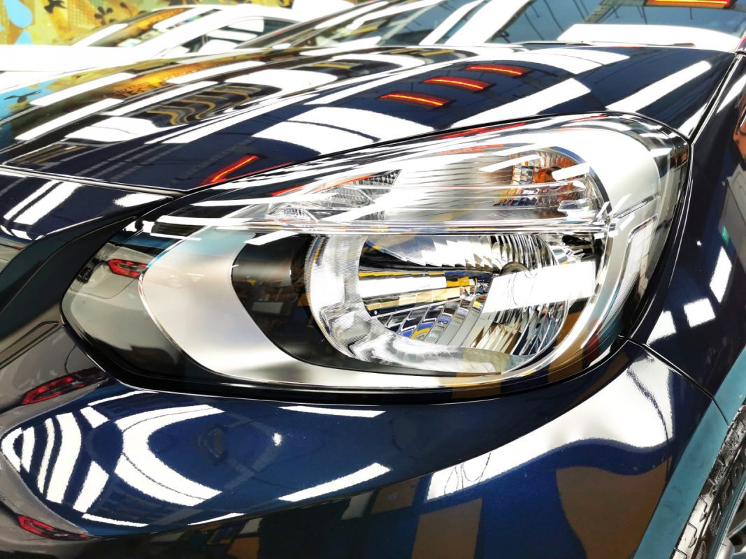 The Fit's coated paintwork holding clean reflections.