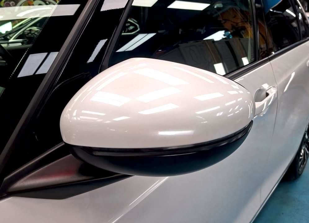 White wing mirror on the Honda Fit with a glossy finish.