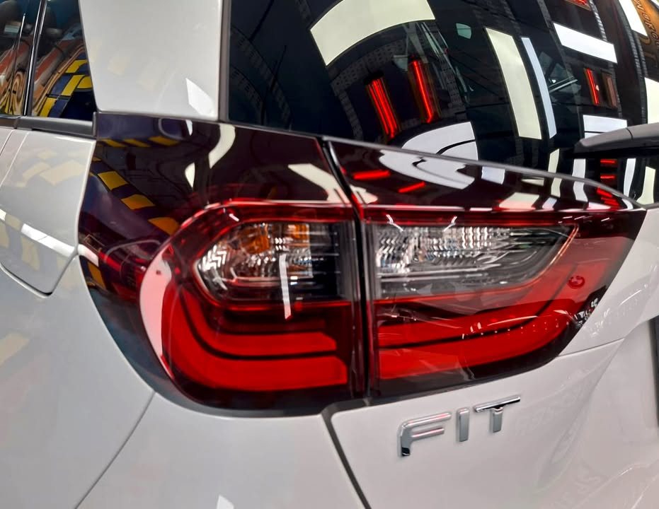 Close-up of the red tail light and Fit badge on the white tailgate.