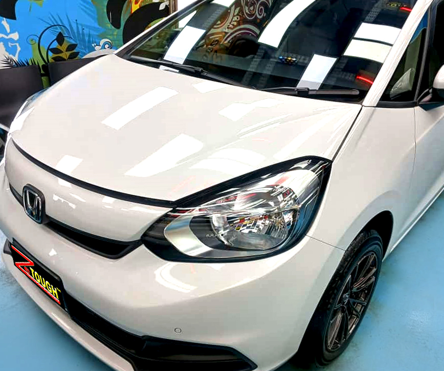 The Honda Fit from a side angle after the ceramic coating.