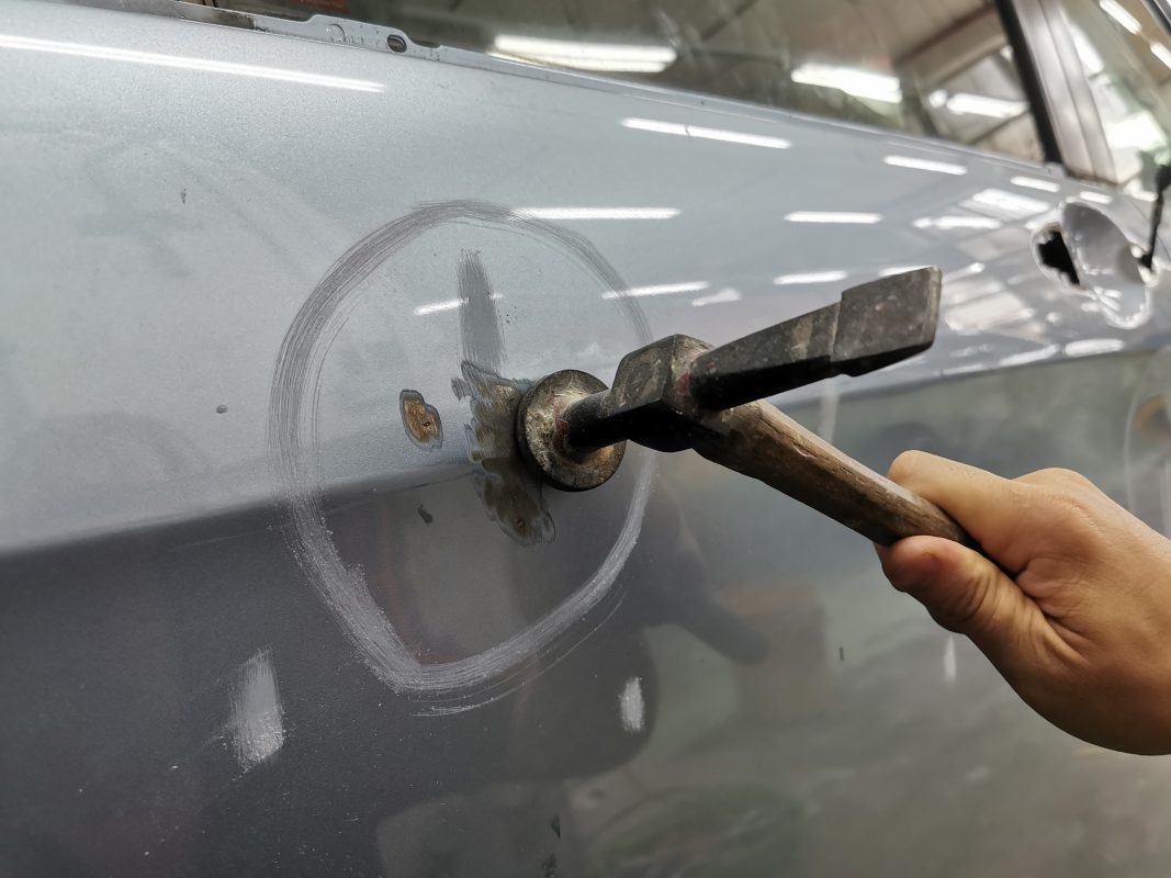 The car's surface inspected and puttied where the paintwork was imperfect.
