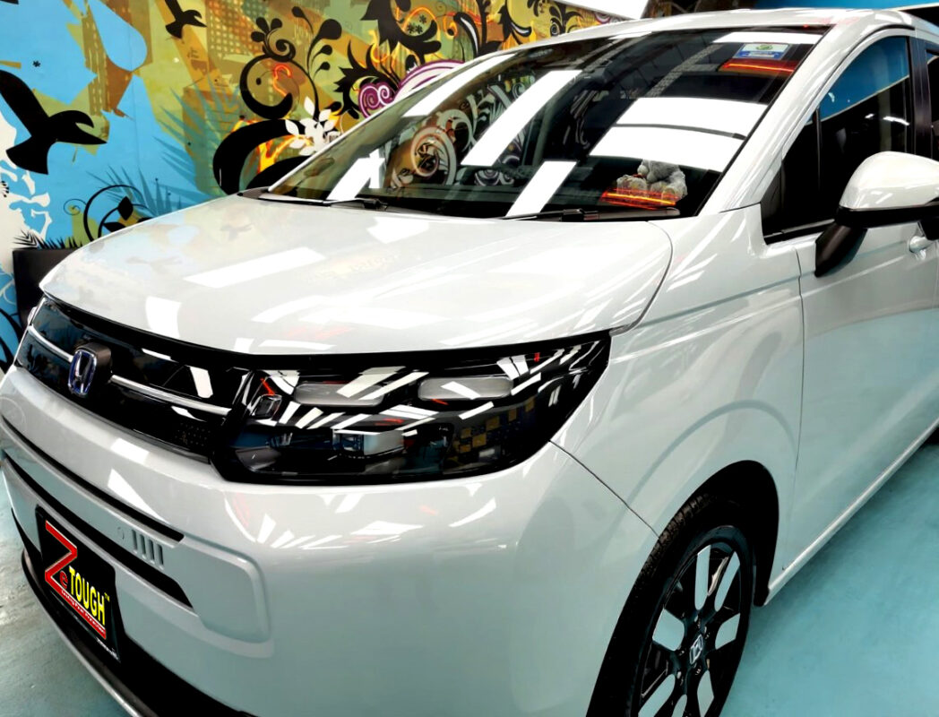 The Honda Freed's coated paintwork under workshop lighting.