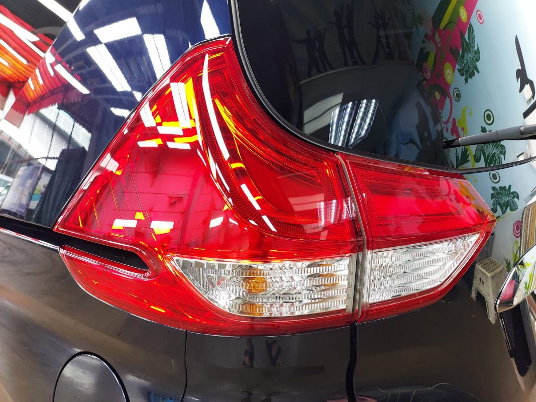 Coated bonnet of the Honda Freed under workshop lighting.