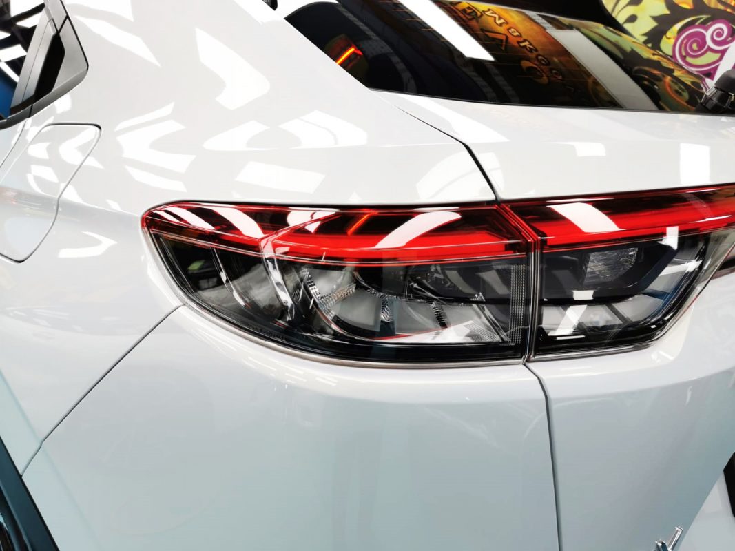 The coated bonnet of the Honda HR-V under workshop lighting.