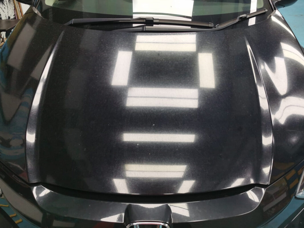 Side view of the Honda HR-V on arrival, paint chips and dull finish visible.