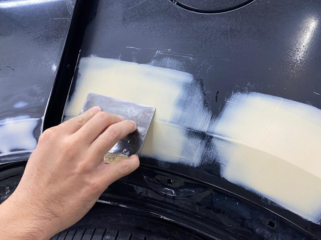 Body filler applied and shaped on a panel of the Honda HR-V.