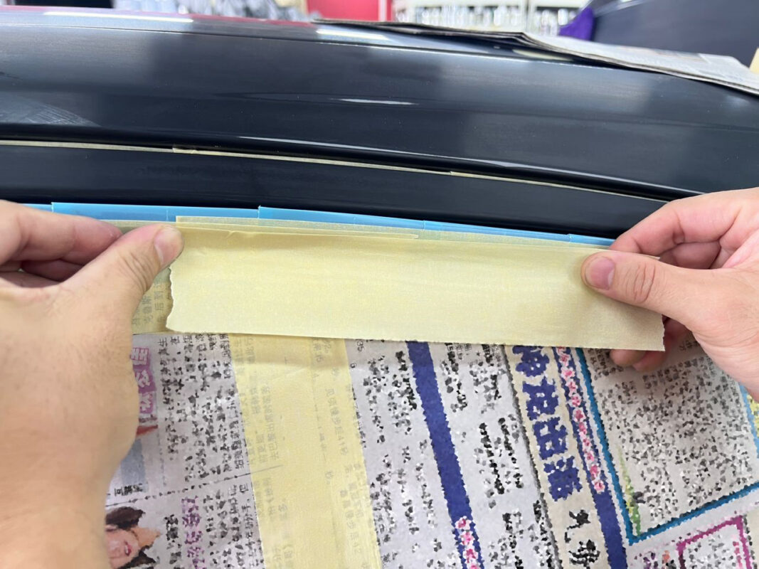 Detail of masking on the Honda HR-V's bumper and trim, taped for precise edges.