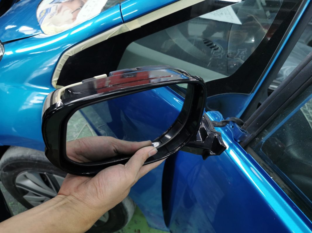 Machine-polishing the Honda Jazz after spraying to bring up the gloss.