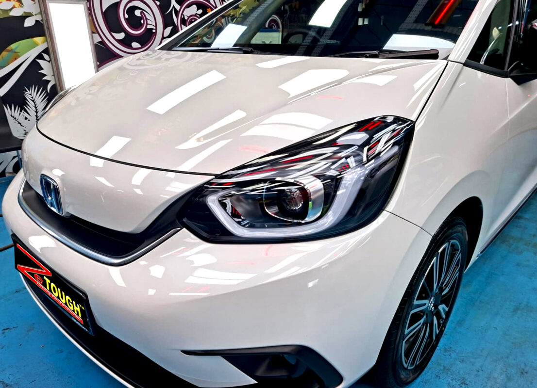 The Honda Jazz's coated paintwork under workshop lighting.