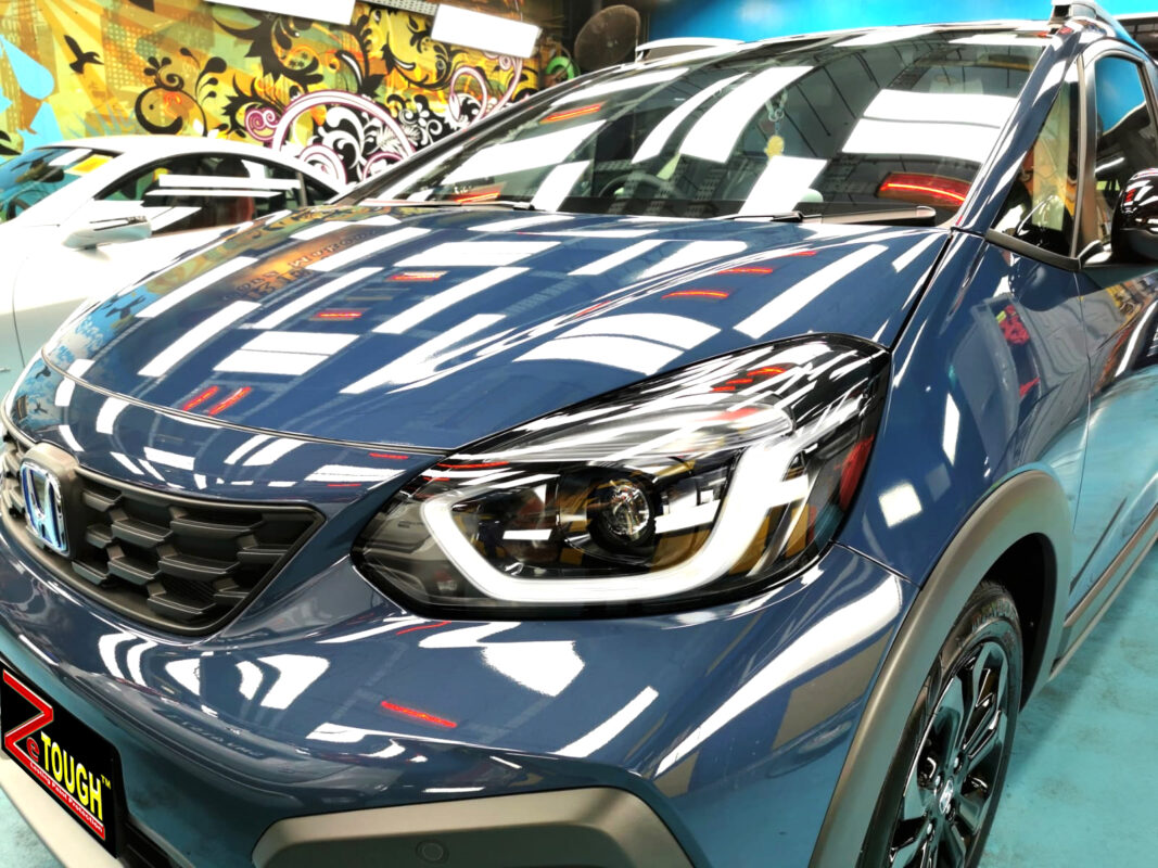 The Honda Jazz's coated paintwork under workshop lighting.