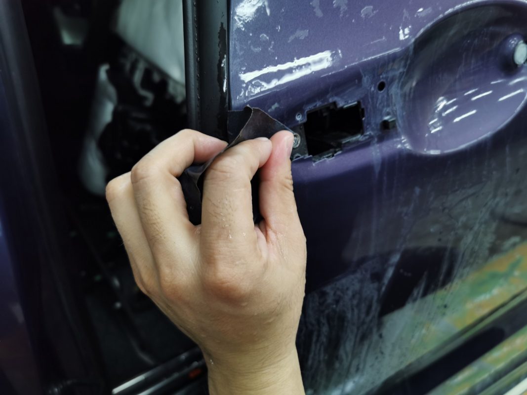 Wet-sanding the Odyssey's panels to smooth the surface.