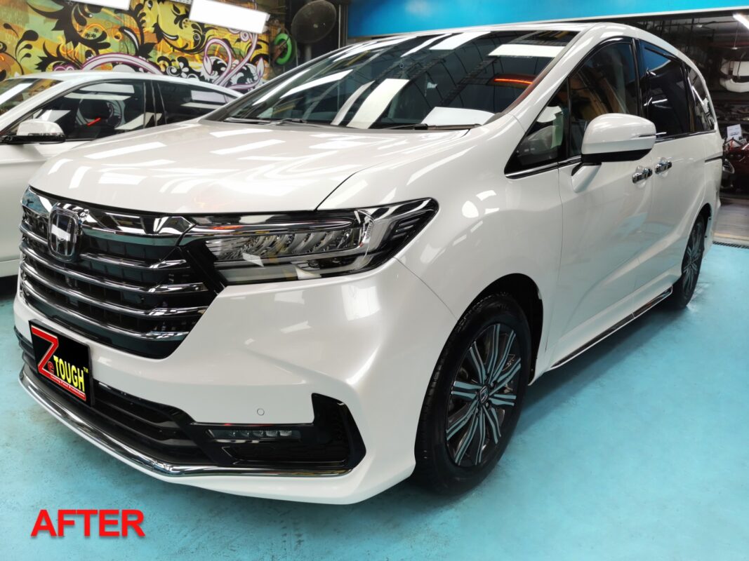 White Honda Odyssey, glossy after its full respray.