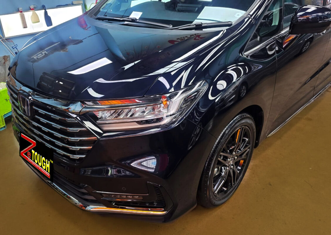 The Honda Odyssey's coated paintwork under workshop lighting.