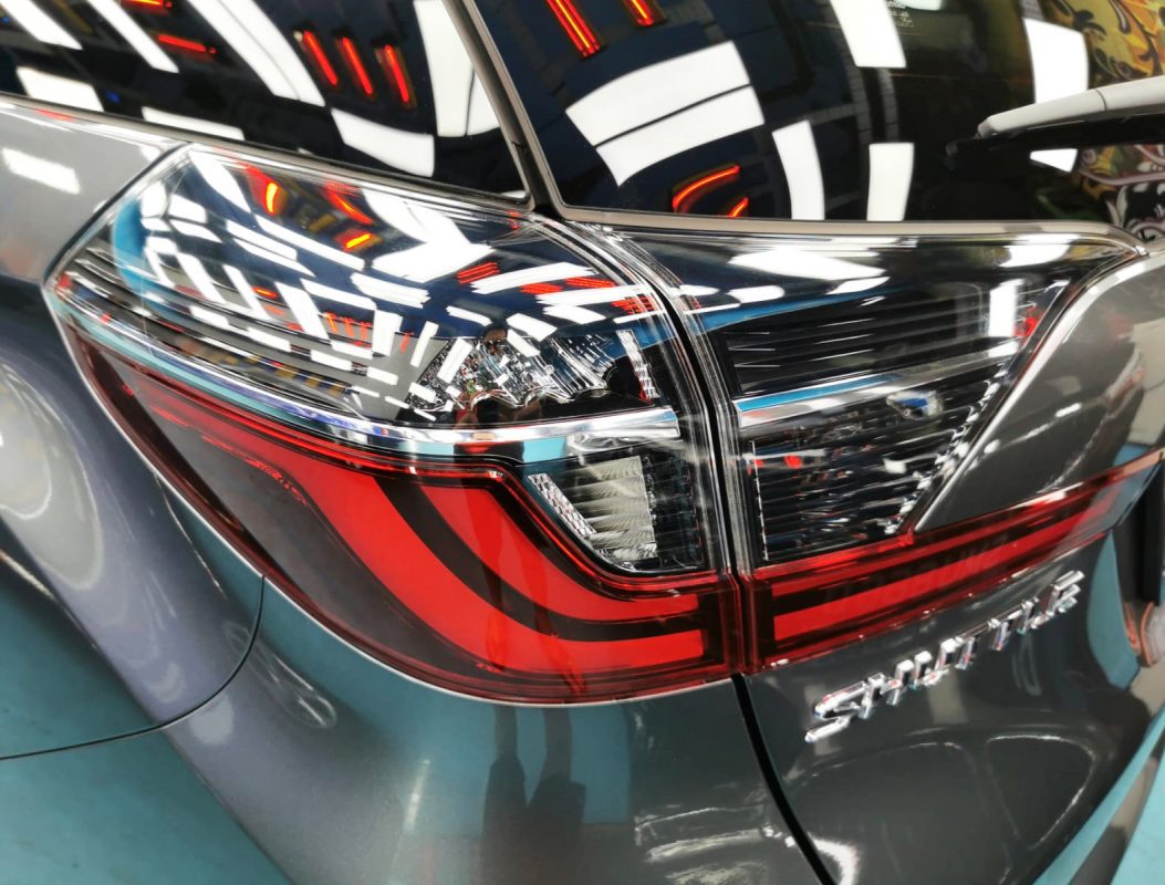 The coated bonnet of the Honda Shuttle under workshop lighting.