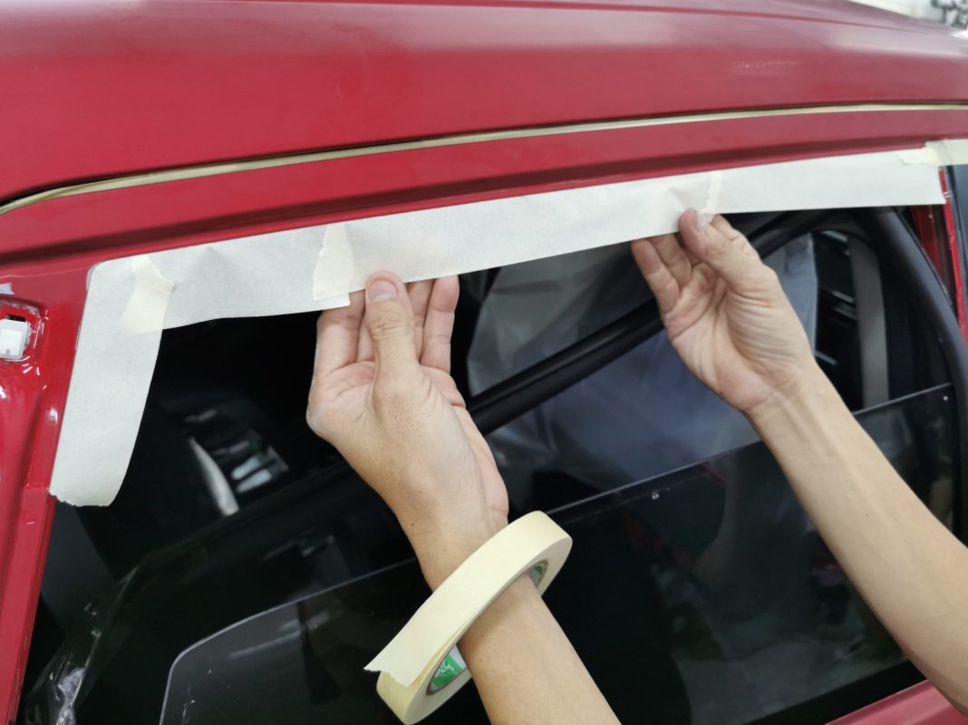 Non-painted surfaces being masked off on the Shuttle before spraying.