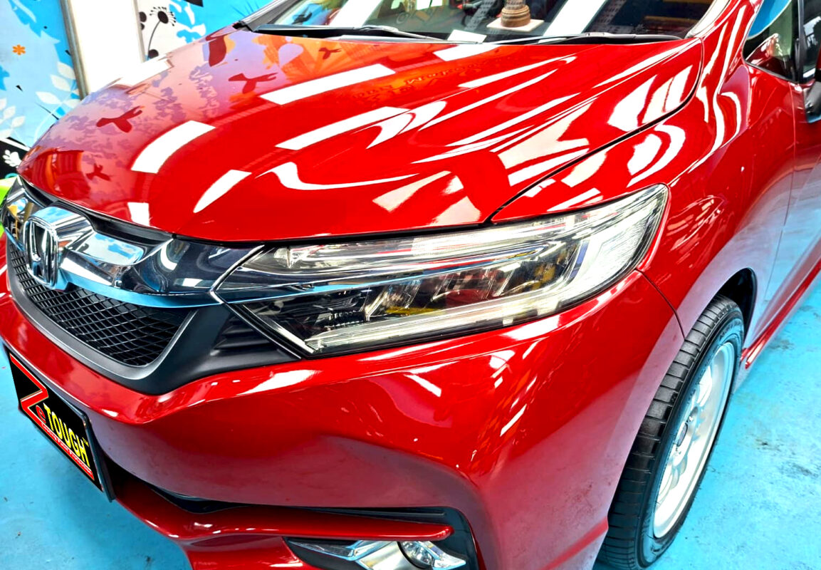 The Honda Shuttle's coated paintwork under workshop lighting.