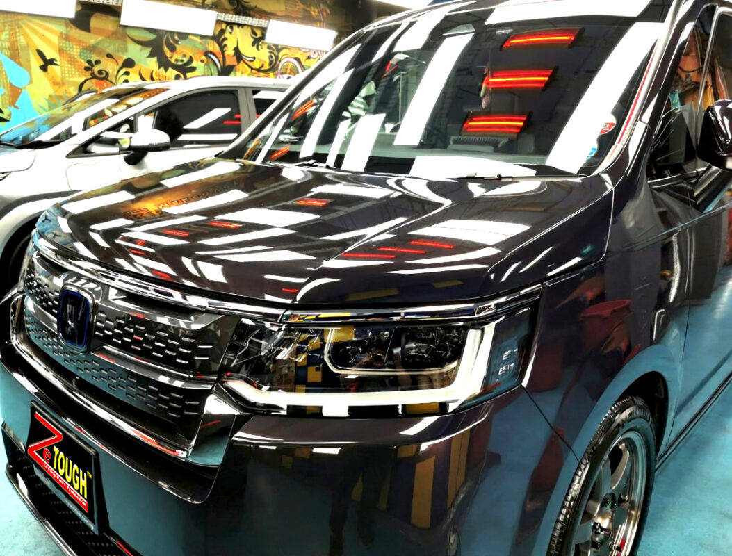 The Honda Stepwagon's coated paintwork under workshop lighting.