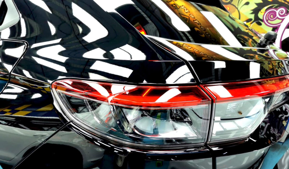 The coated bonnet of the Honda Vezel under workshop lighting.