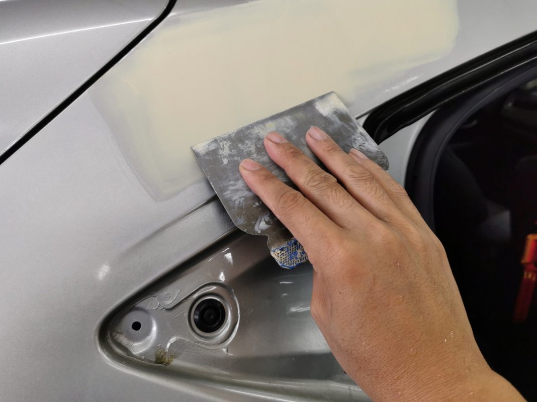 The car's surface inspected and patched where the paintwork was imperfect.