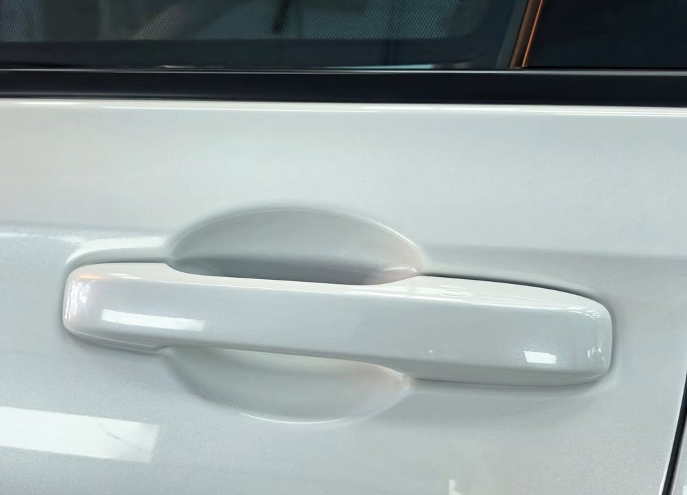 White door handle and door panel close-up.