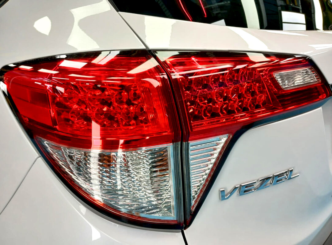 The coated bonnet of the Honda Vezel under workshop lighting.