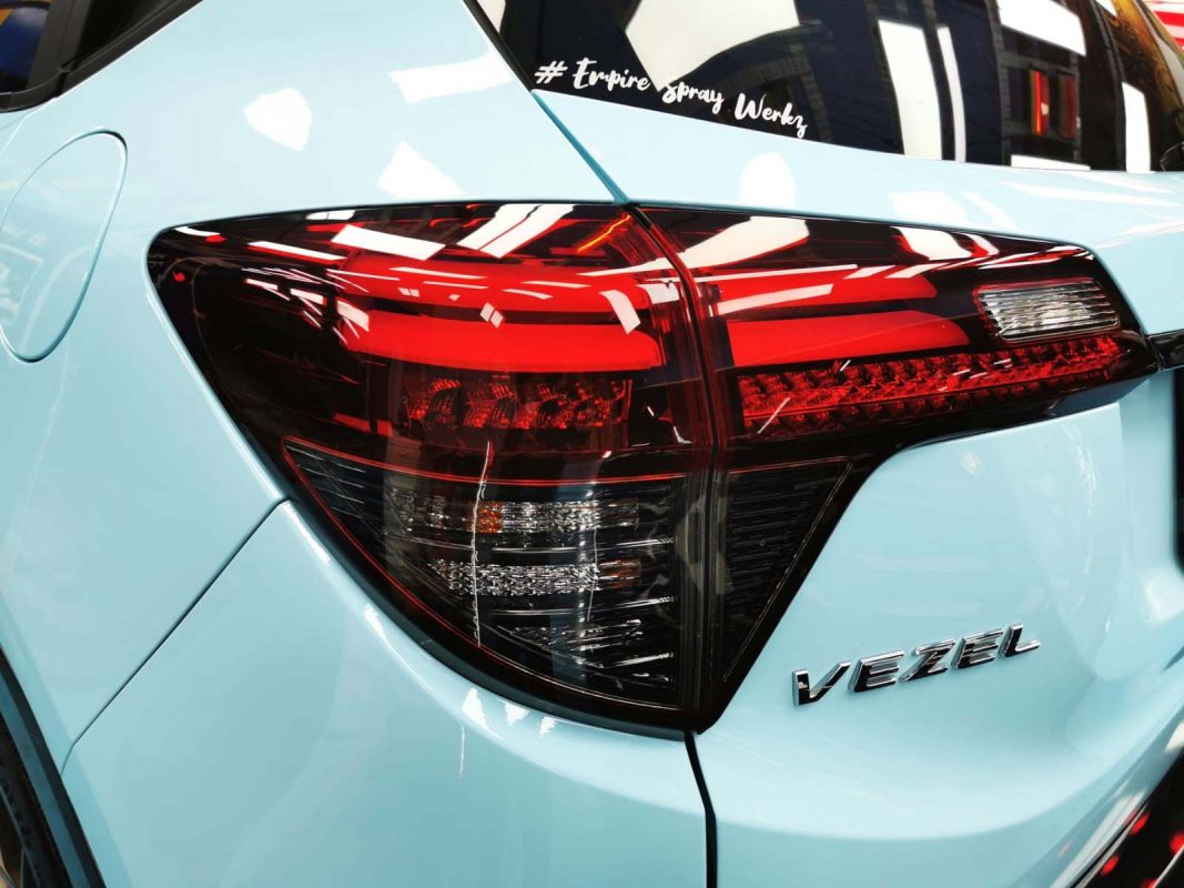 The coated bonnet of the Honda Vezel under workshop lighting.