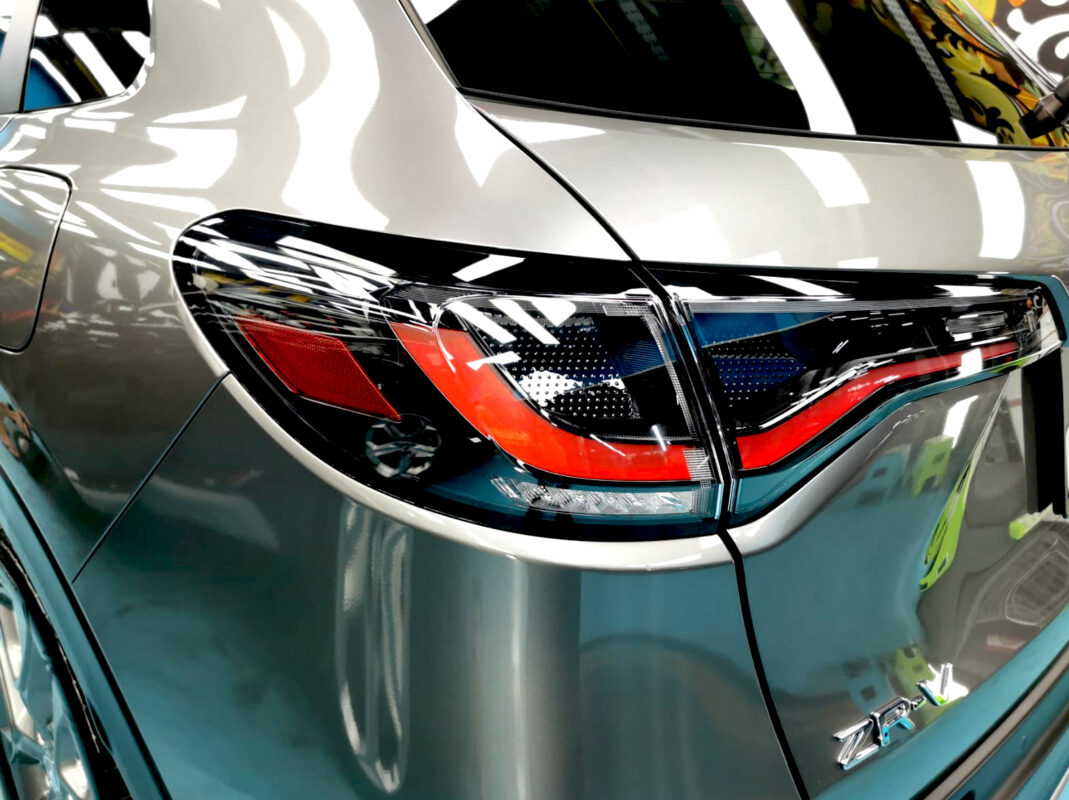 The coated bonnet of the Honda ZR-V under workshop lighting.