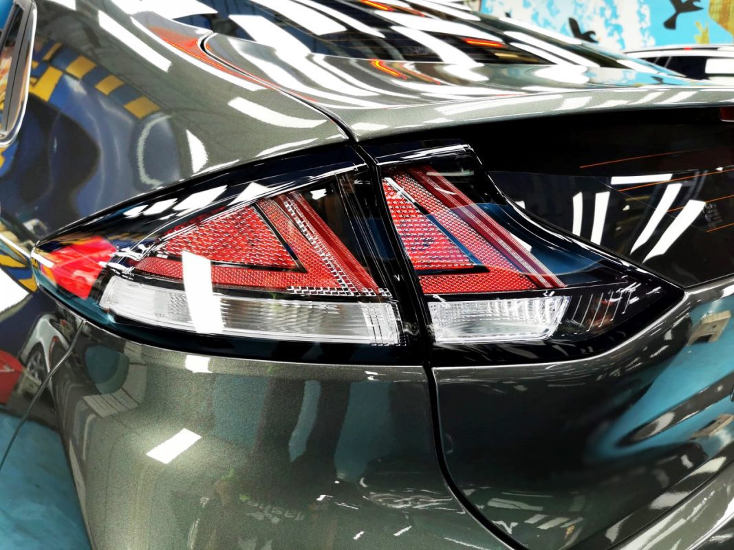 The coated bonnet of the Hyundai Ioniq under workshop lighting.