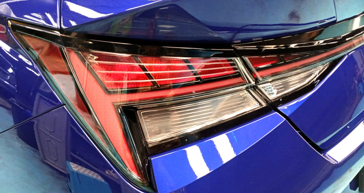 The coated bonnet of the Hyundai Avante under workshop lighting.