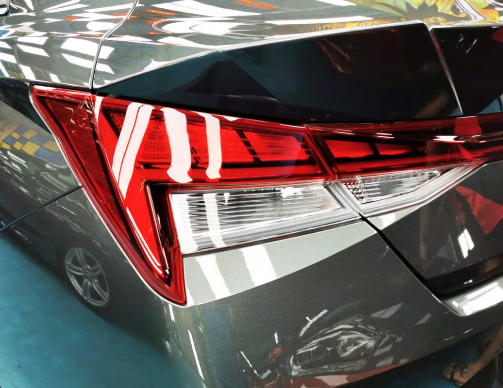 The coated bonnet of the Avante under workshop lighting.