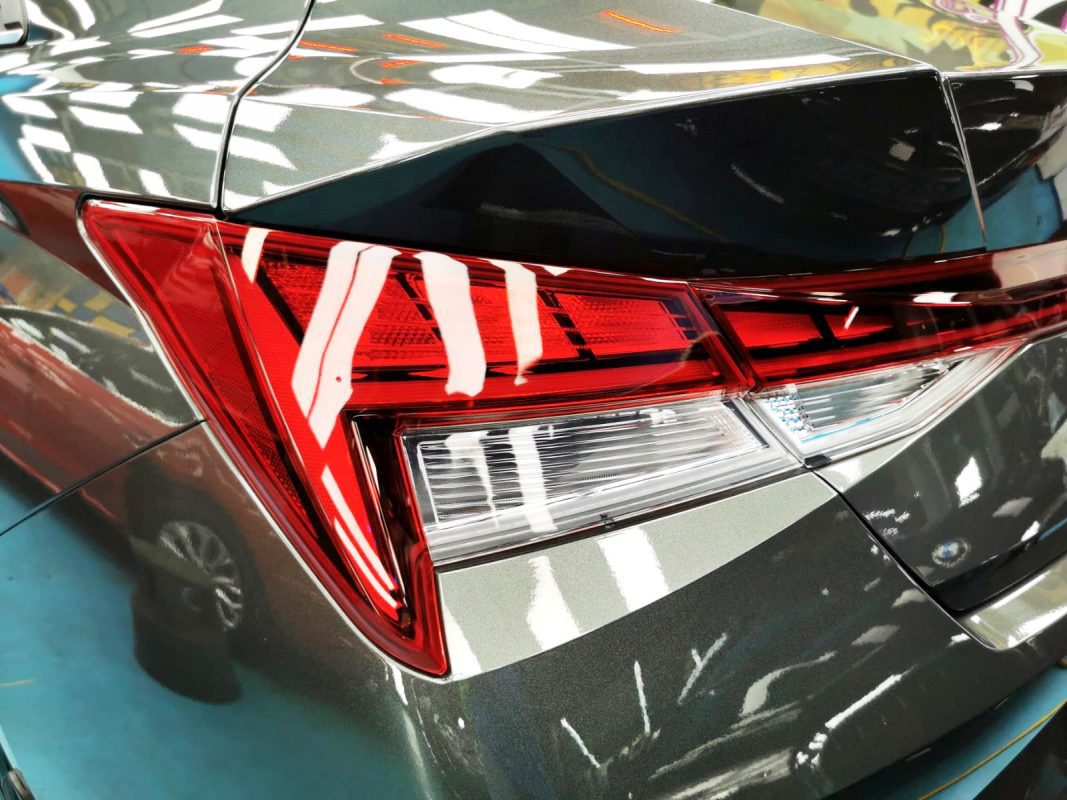 The coated bonnet of the CN7 Avante under workshop lighting.