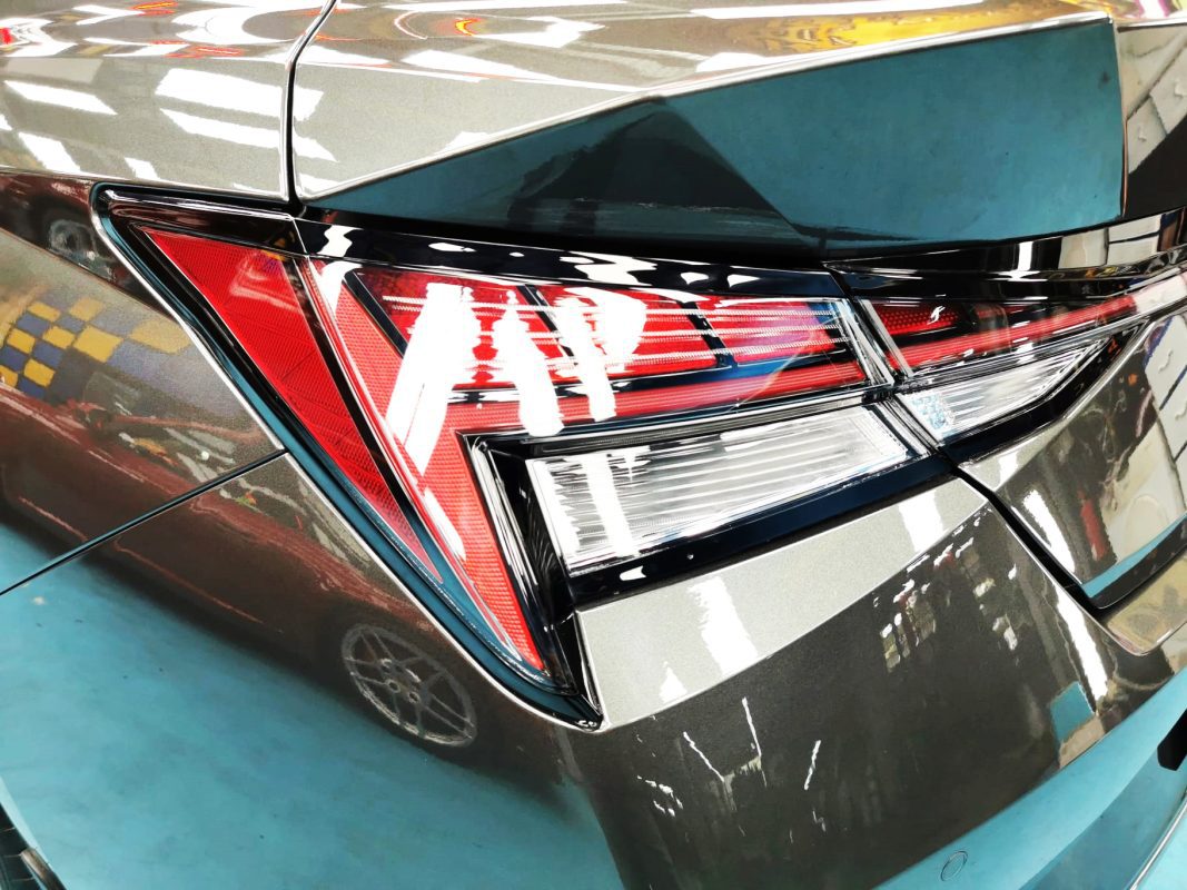 The coated bonnet of the Hyundai CN7 under workshop lighting.