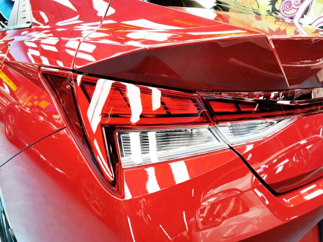 The coated bonnet of the Hyundai CN7 under workshop lighting.
