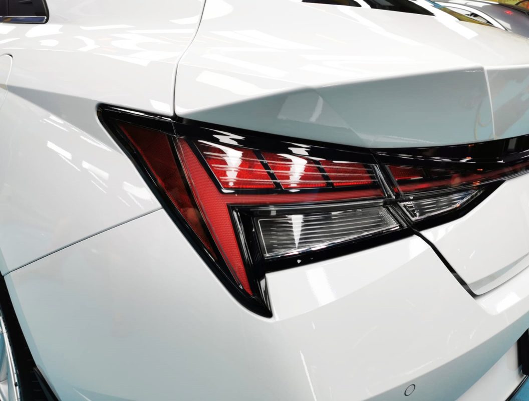 The coated bonnet of the Hyundai CN7 under workshop lighting.