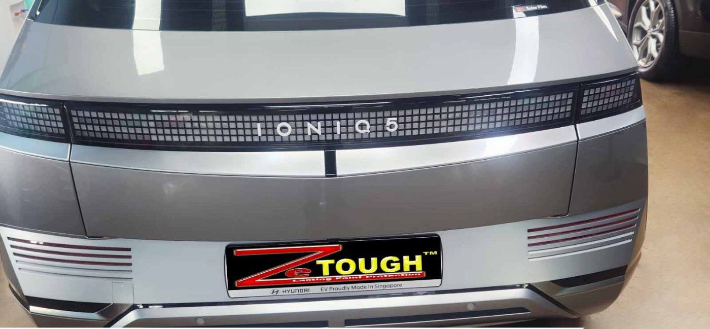 The coated bonnet of the Hyundai Ioniq 5 under workshop lighting.