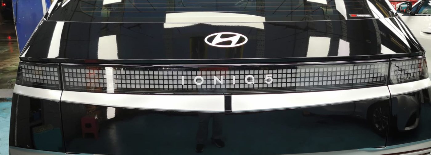 The coated bonnet of the Hyundai Ioniq 5 under workshop lighting.