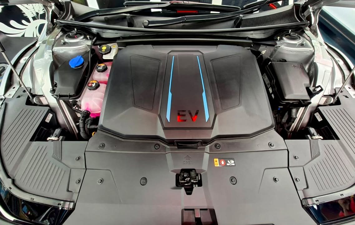 Motor bay under the bonnet with the EV cover.
