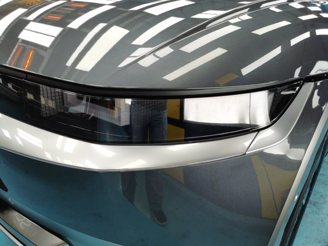 The Ioniq5's coated paintwork showing clean reflections.