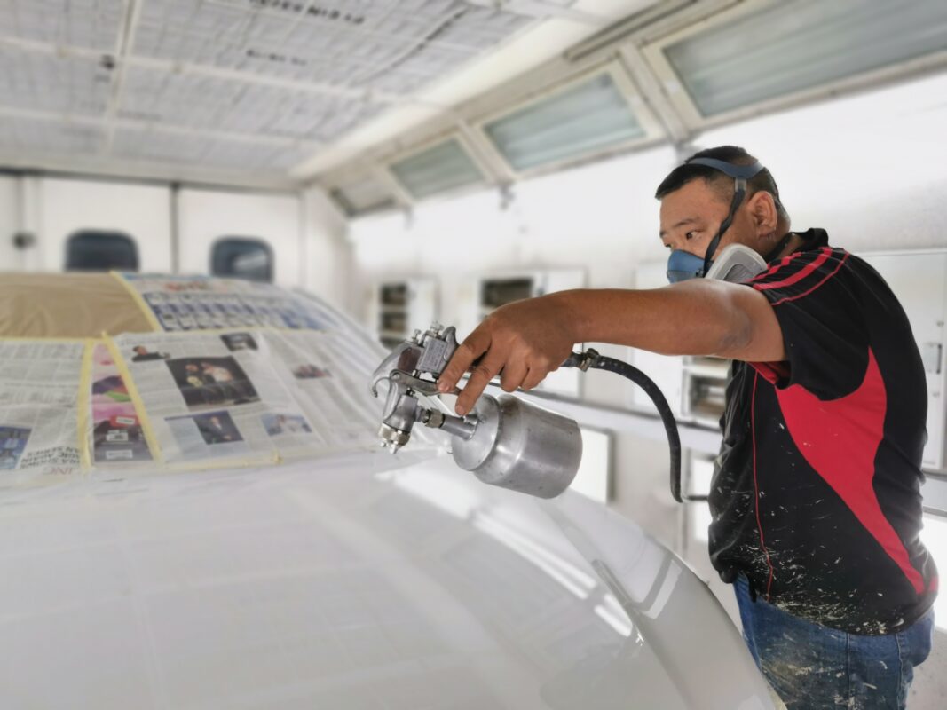 New colour coat being applied to the Hyundai Sonata inside the spray booth.