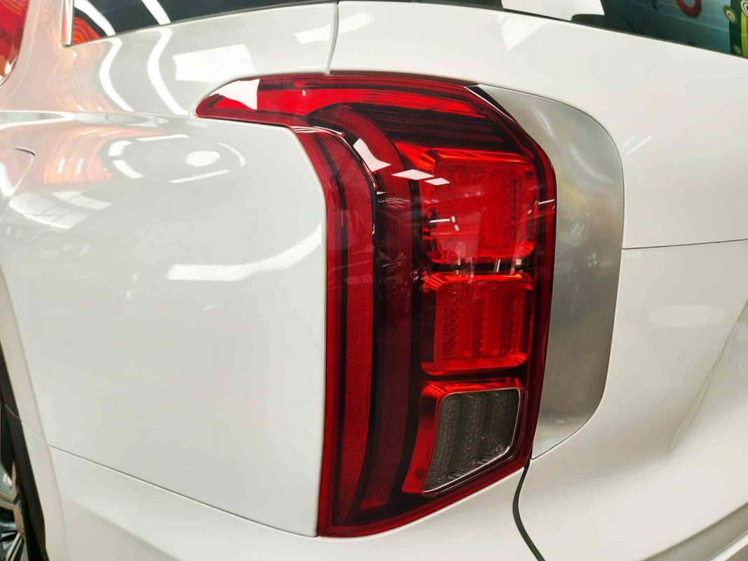 The coated bonnet of the Hyundai LX2 Palisade under workshop lighting.
