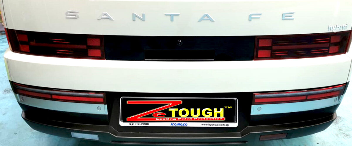 The coated bonnet of the Hyundai Santa Fe under workshop lighting.